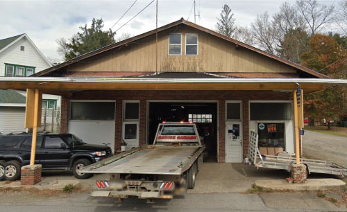 Photo of the front of Gaines Garage in Gaines PA with flatbed truck for long distance towing